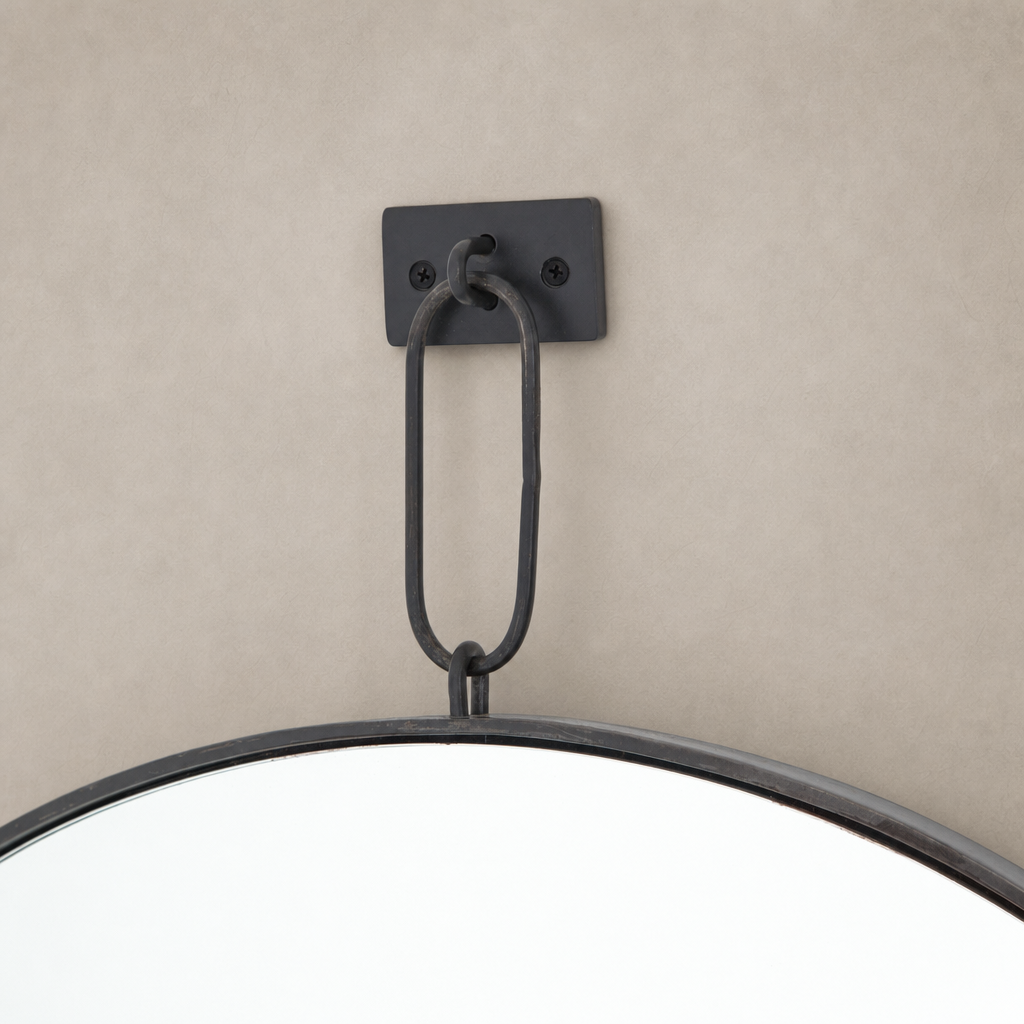 Vida Mirror featuring a sleek black metal hanging loop and rounded edge design.