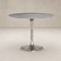 Kensington Bistro Table in Raw Antique Nickel with a sleek round top and slender pedestal.