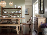 Camden Large Bookshelf featuring natural wood, elegantly displaying dishes and decorative items.